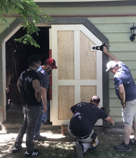 Local volunteers and Sarah Mooney board members spent a recent Saturday replacing the museum's carriage door.